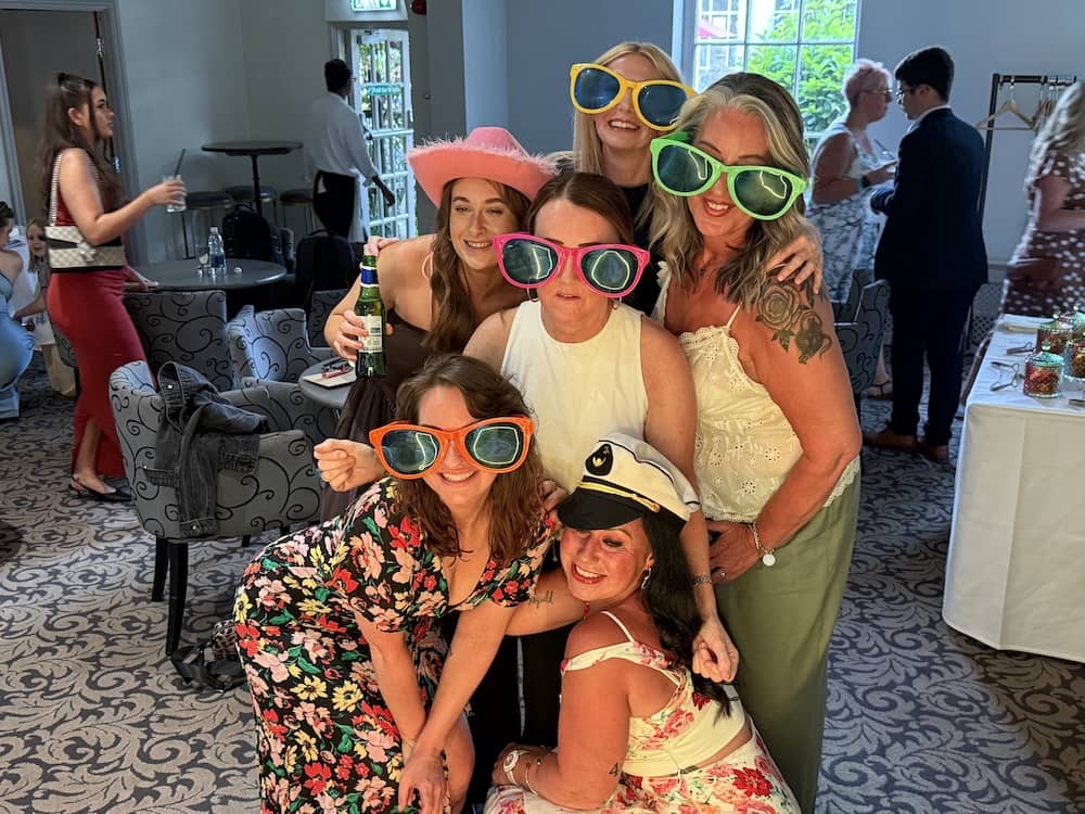 Wedding guests posing with props at The Bridge Hotel
