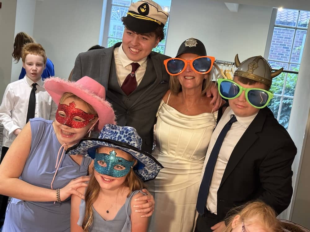 Family and grandchildren gathering for a Magic Mirror photo at The Bridge