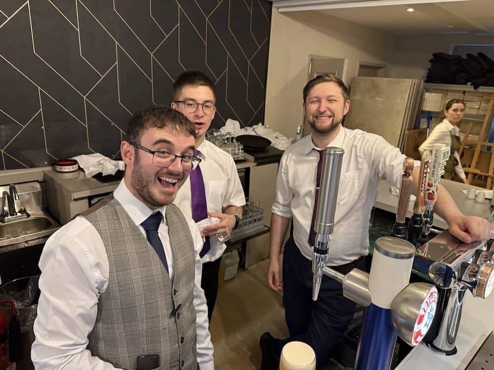 Members of The Bridge team behind the bar