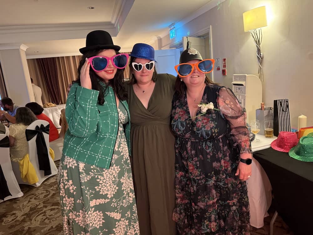 Guests posing with colourful props at The Bridge Hotel wedding