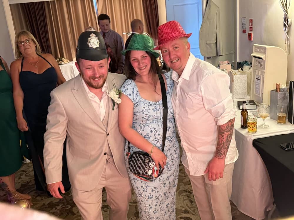 Group photo with Magic Mirror props at Tyler and Josh's wedding