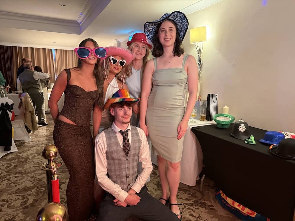 Wedding guests using heart glasses and props at The Bridge Hotel