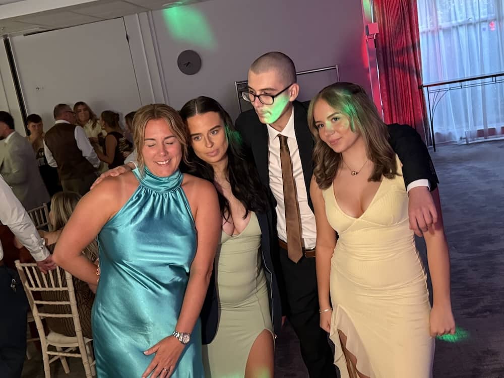 Group of wedding guests using Magic Mirror props at Delta York