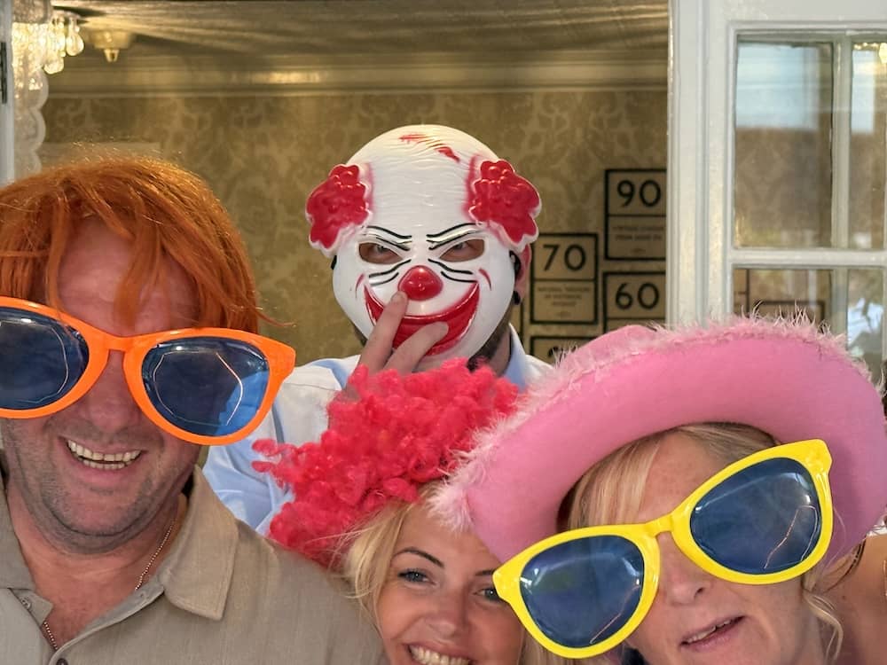 Guests wearing funny props at the Magic Mirror at Dimplewell Lodge