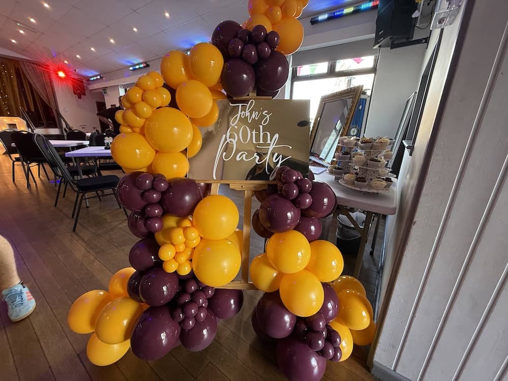 Burgundy and gold balloon display for John's 60th birthday