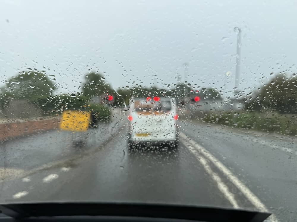 Driving through heavy rain on the way to a Fairfield Manor wedding