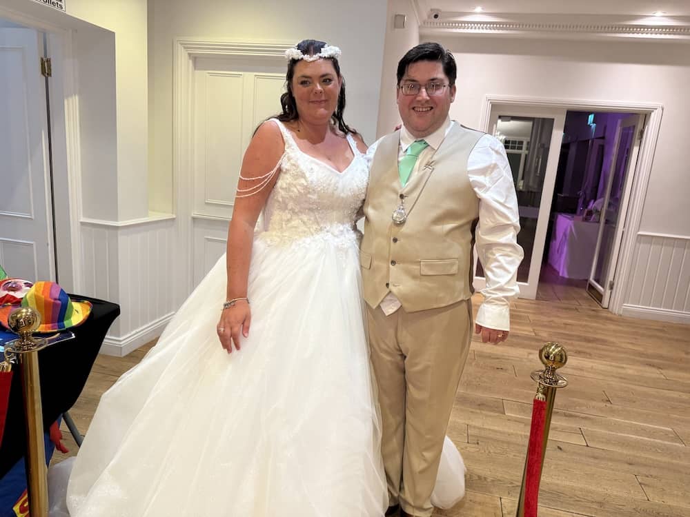 Bride and groom posing together at the Magic Mirror