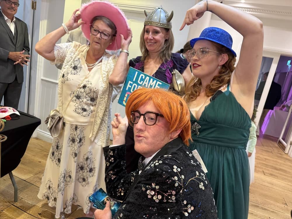 Wedding guests using colourful props at the Magic Mirror