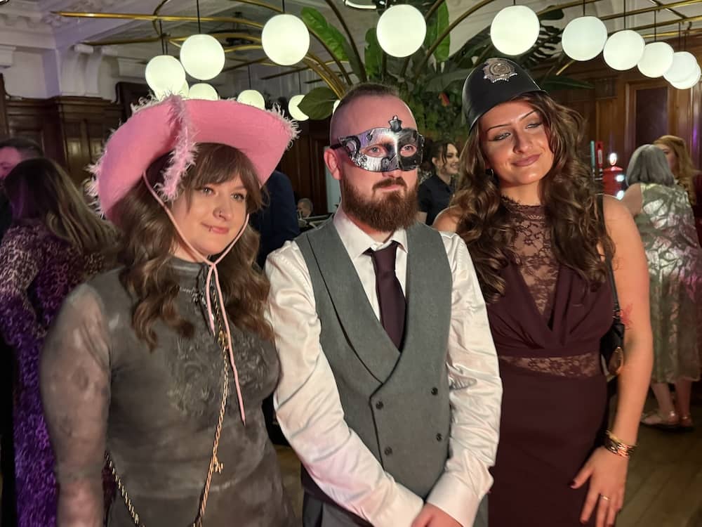 Wedding guests wearing hats and props at the Magic Mirror