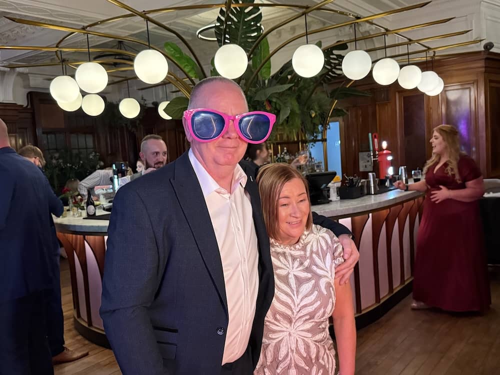 Wedding guests using props at the Magic Mirror at Impossible York