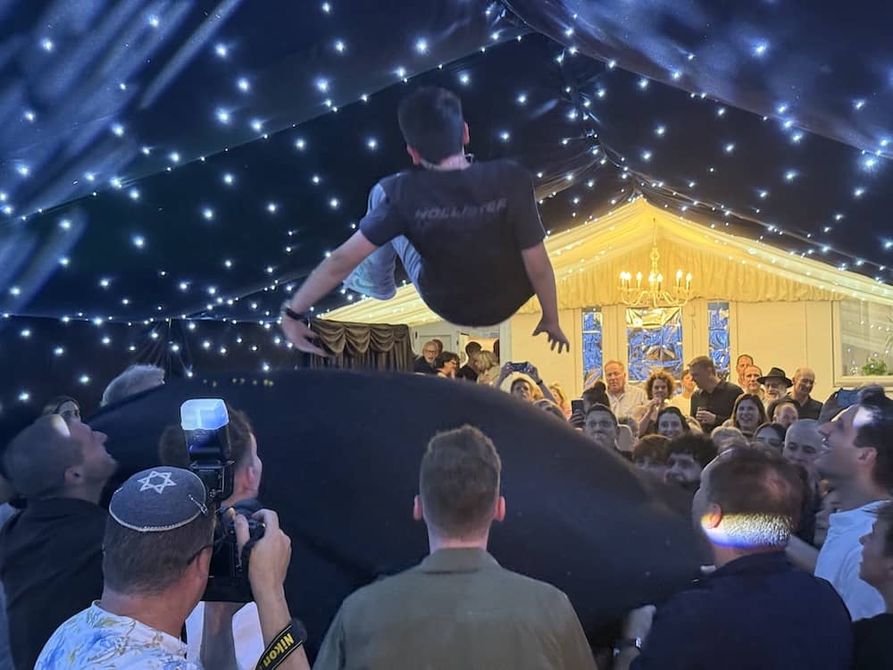 Joe being thrown into the air on a cloth during his Bar Mitzvah