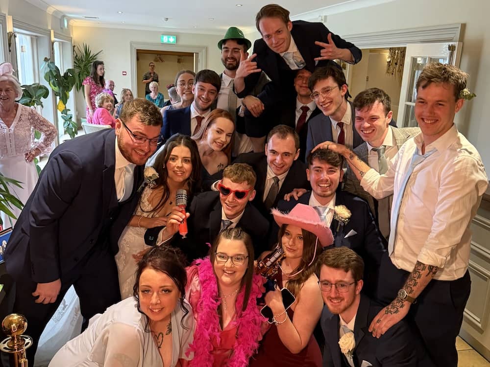 Large group of wedding guests gathered around the Magic Mirror