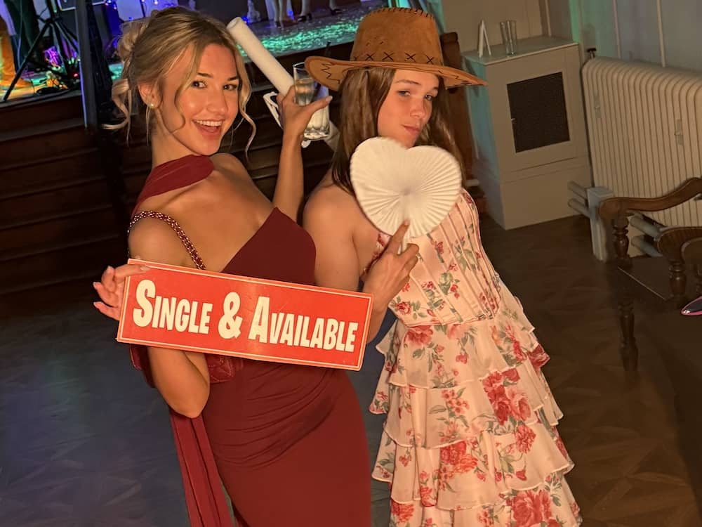 Wedding guests using props and laughing together