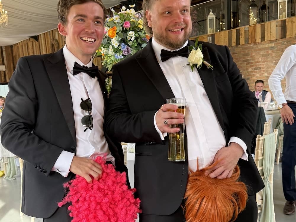 Wedding guests having fun with colourful wigs at a Yorkshire wedding