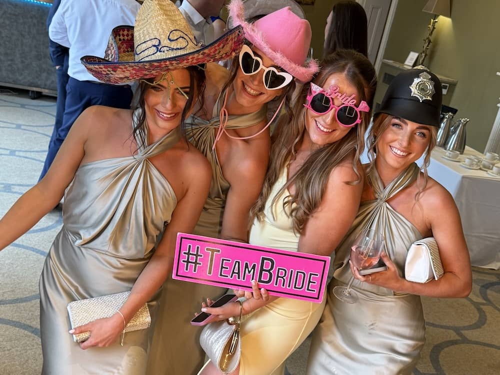 Group of wedding guests posing at Magic Mirror at Rudding Park