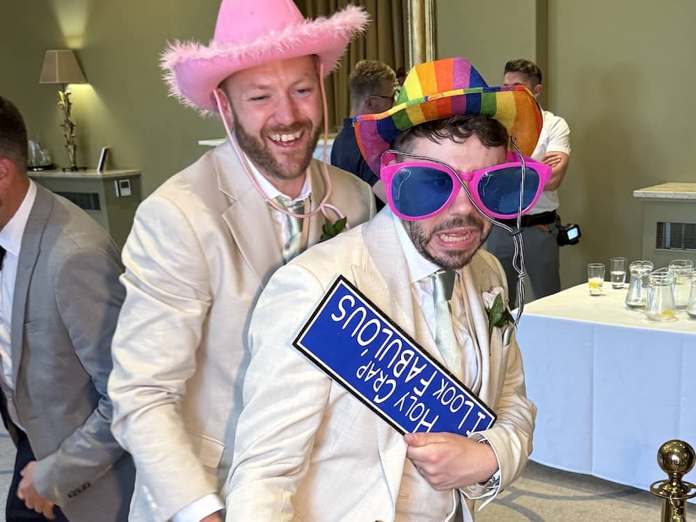 Wedding guests using props at Rudding Park Magic Mirror