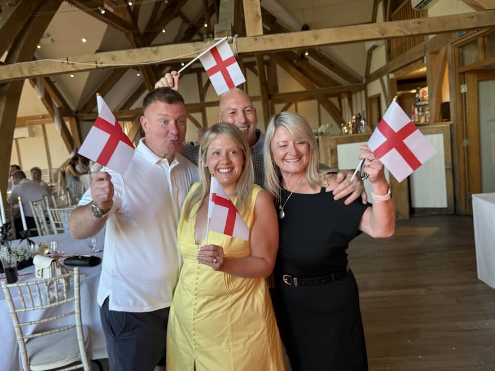 Wedding guests holding England flags at Sandburn Hall