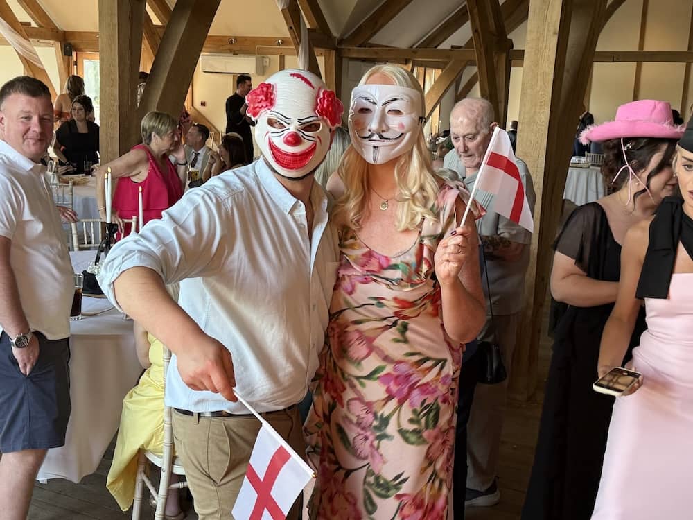 Wedding guests posing for a Magic Mirror group photo at Sandburn Hall