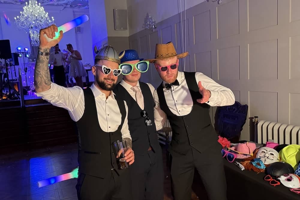 Groomsmen using Magic Mirror with props at Thicket Priory wedding