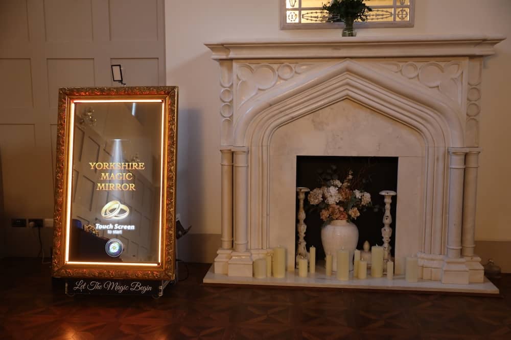 Magic Mirror setup in front of fireplace at Thicket Priory wedding venue