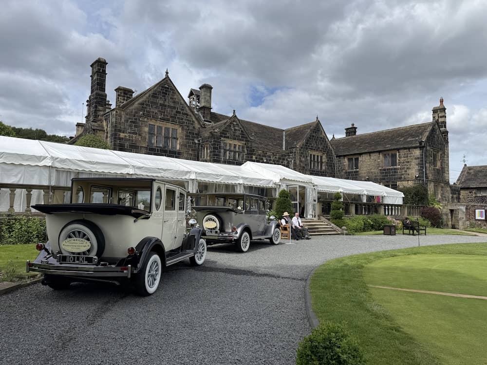 Vintage wedding cars outside Woodsome Hall