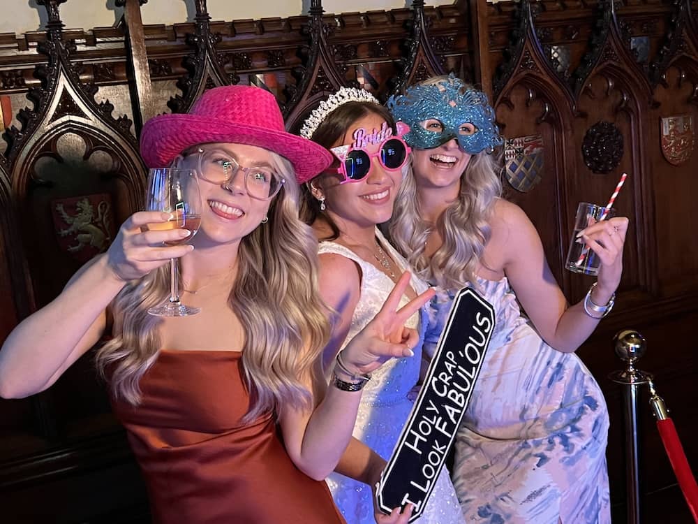 Wedding guests posing at Magic Mirror photo booth at Allerton Castle