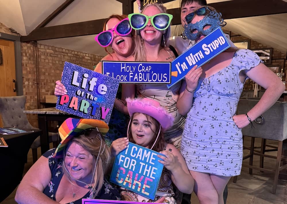 Wedding guests posing with props at Beverley Barn photo booth