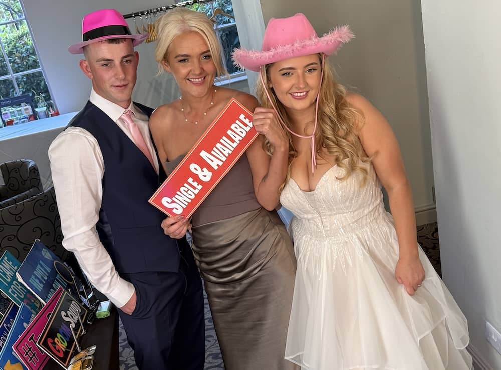 Wedding guests posing with props at Magic Mirror photo booth at The Bridge Hotel & Spa